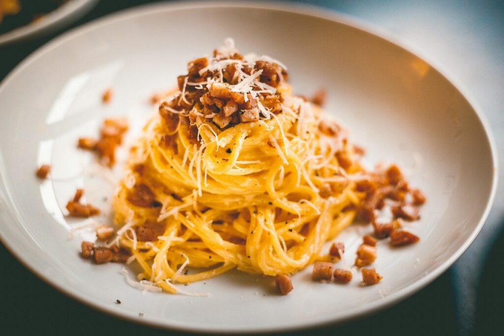 Menu Spaghetti Carbonara with bacon and Parmesan on a plate