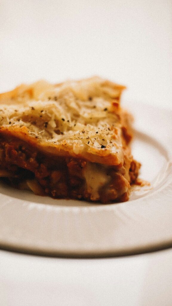 Menu A piece of lasagne on a white plate